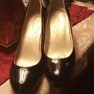 A pair of black patent leather heels